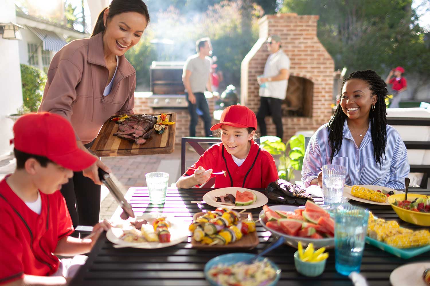 Little League families enjoying an after the game grilling
