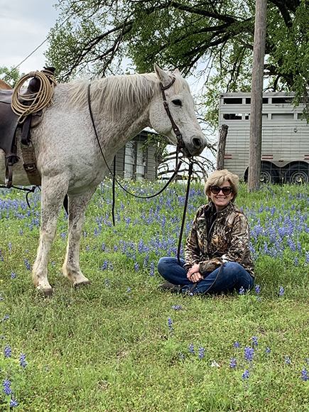 Molly on the ranch with her horse.