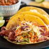 Stout Braised Corned Beef Tacos with Fiery Cabbage Slaw