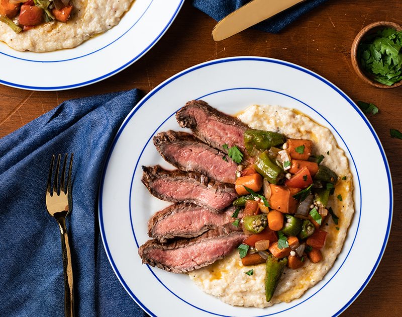 Creole Flank Steak with Sautéed Vegetables and Cheese Grits image