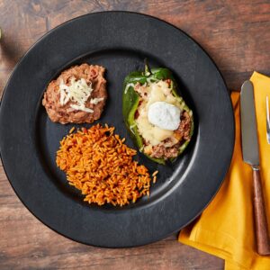 Beef Picadillo Stuffed Peppers with Mexican Rice and Refried Beans